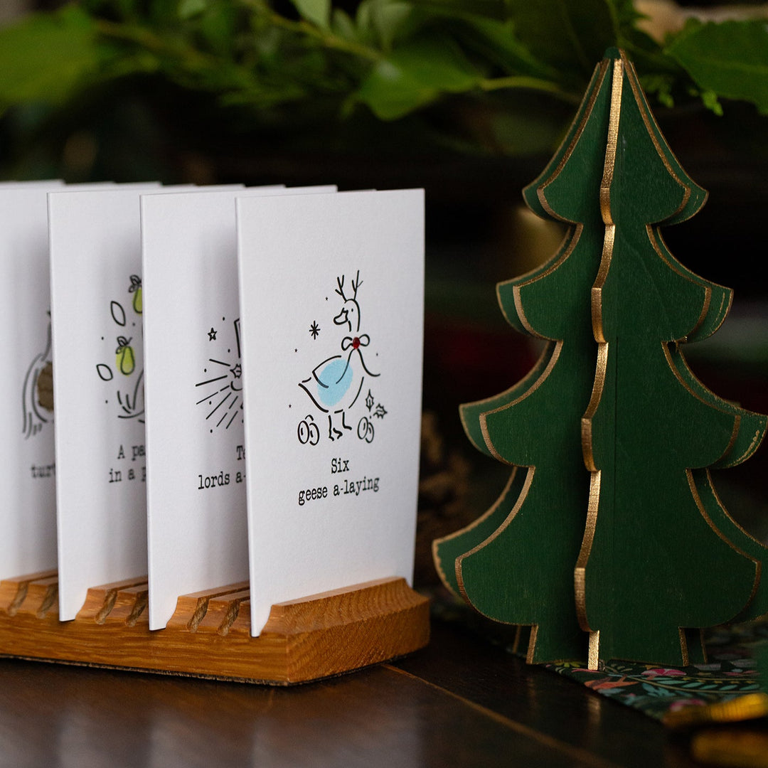 Set of greeting cards with a decorative tree on a wooden surface
