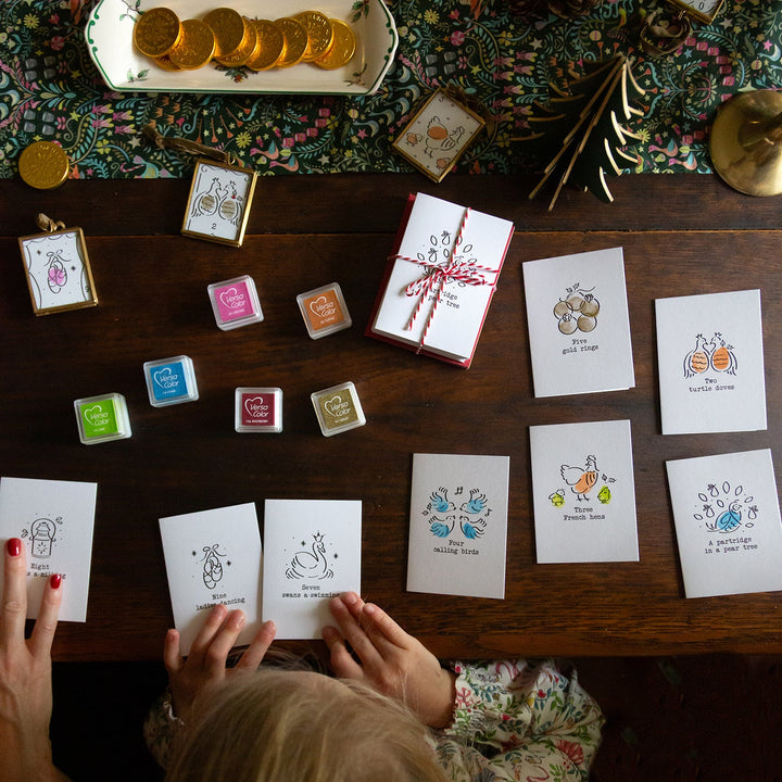 Person looking at greeting cards on a table with decorative items