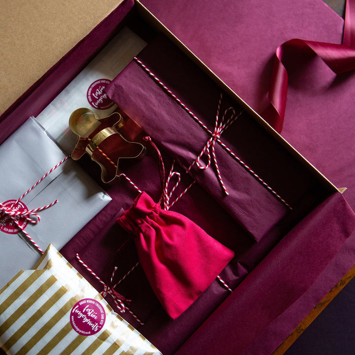 Gift box with decorative items on a wooden surface