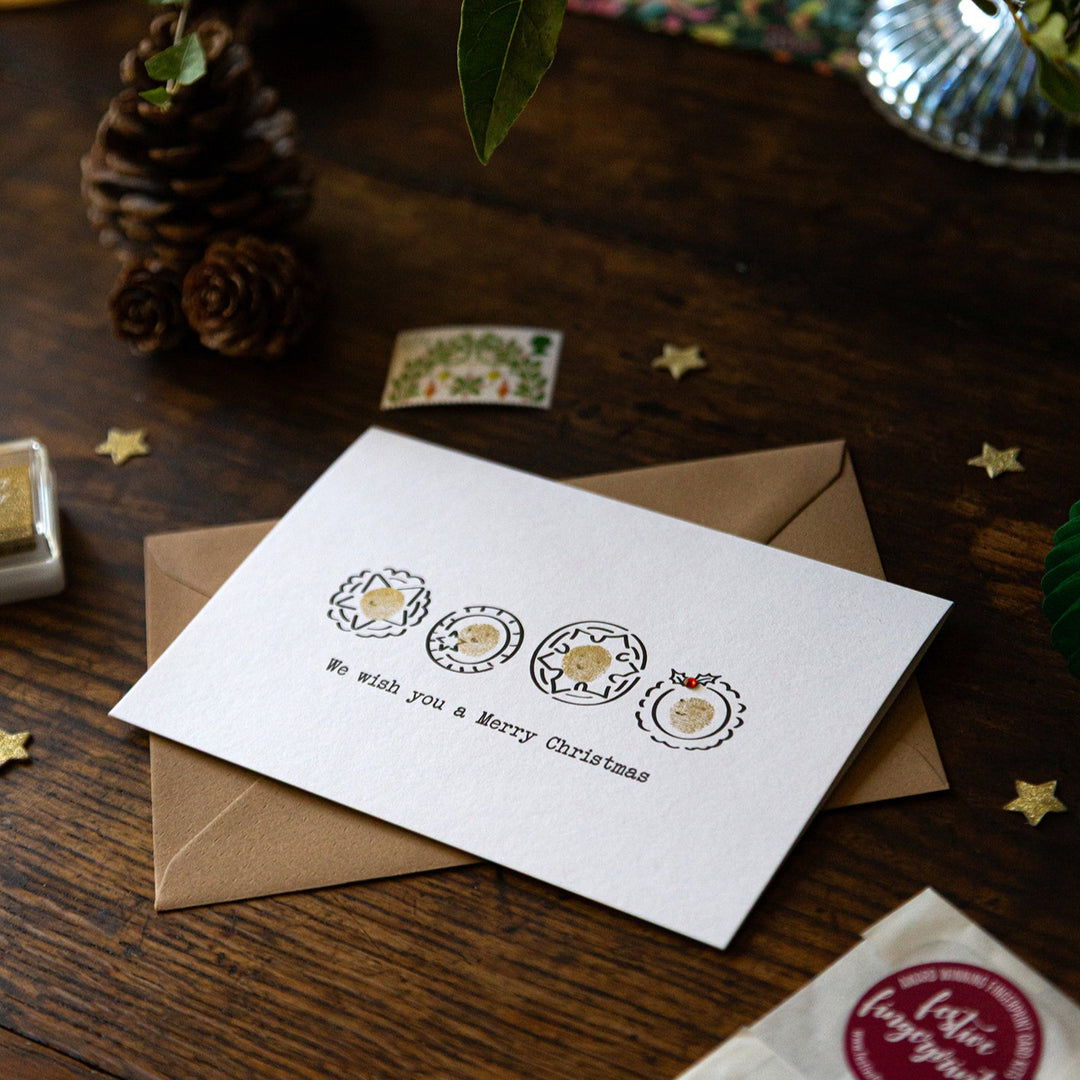 Christmas card with envelope on a wooden surface with decorative elements
