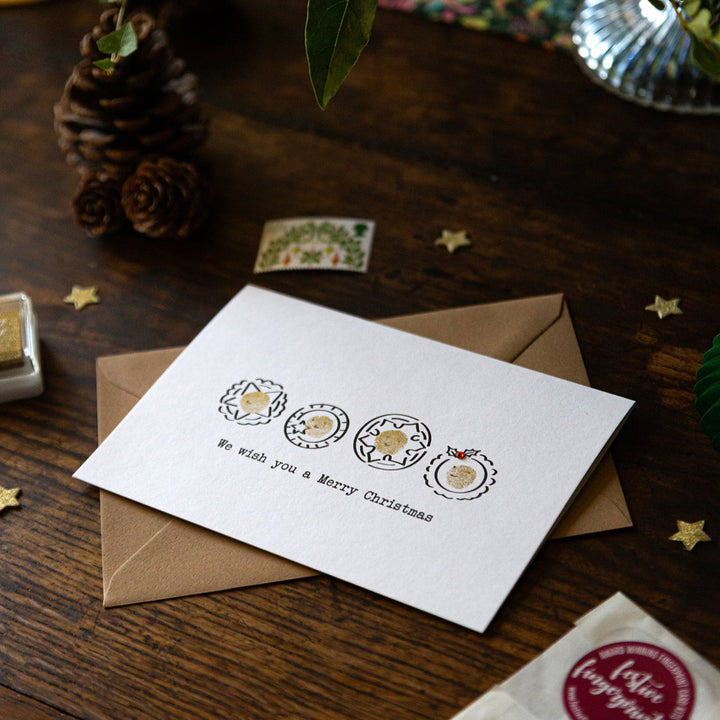 Christmas card with envelope on a wooden surface with decorative elements